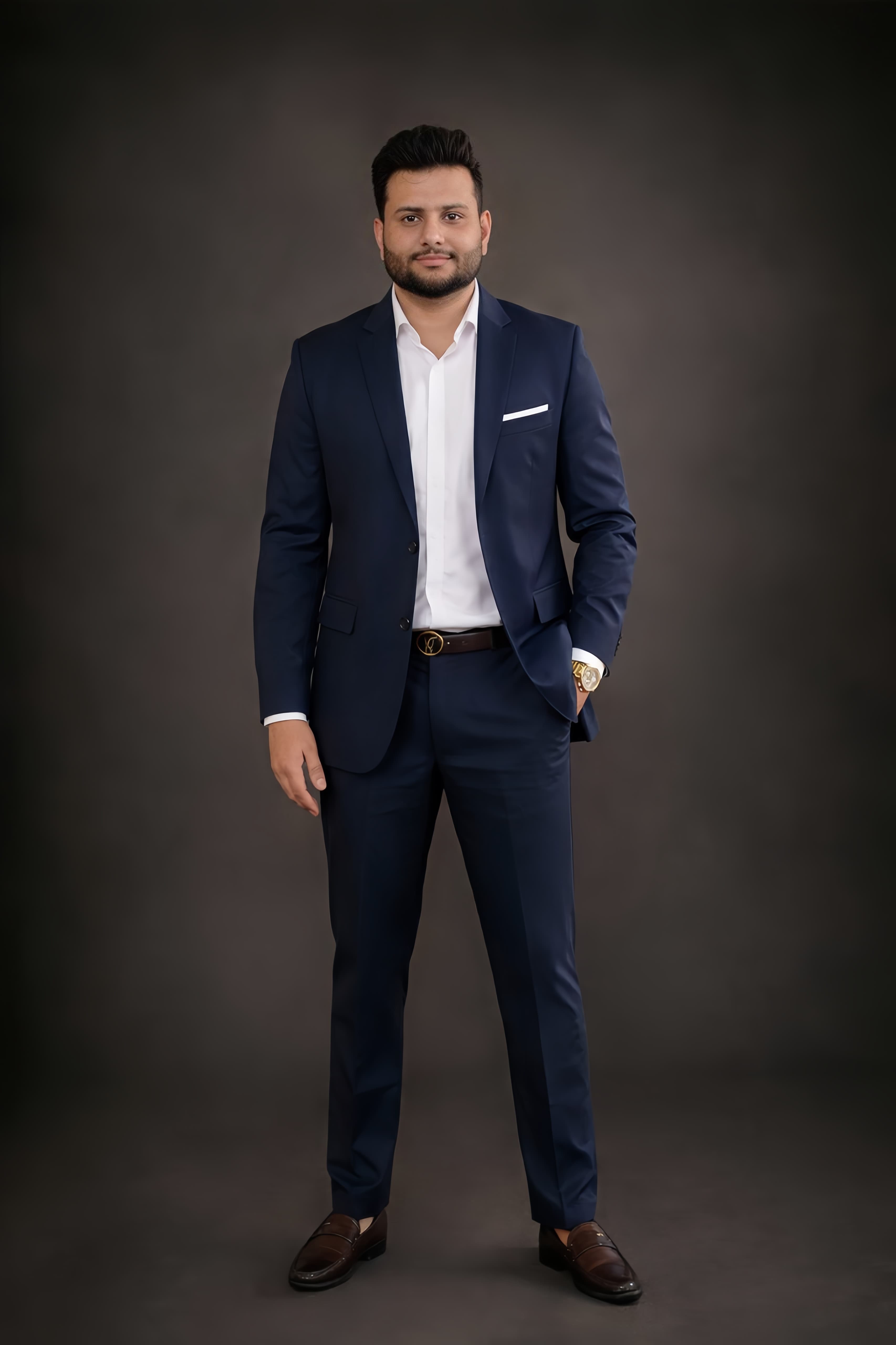 Professional full-body portrait of Shubham Verma in a navy suit